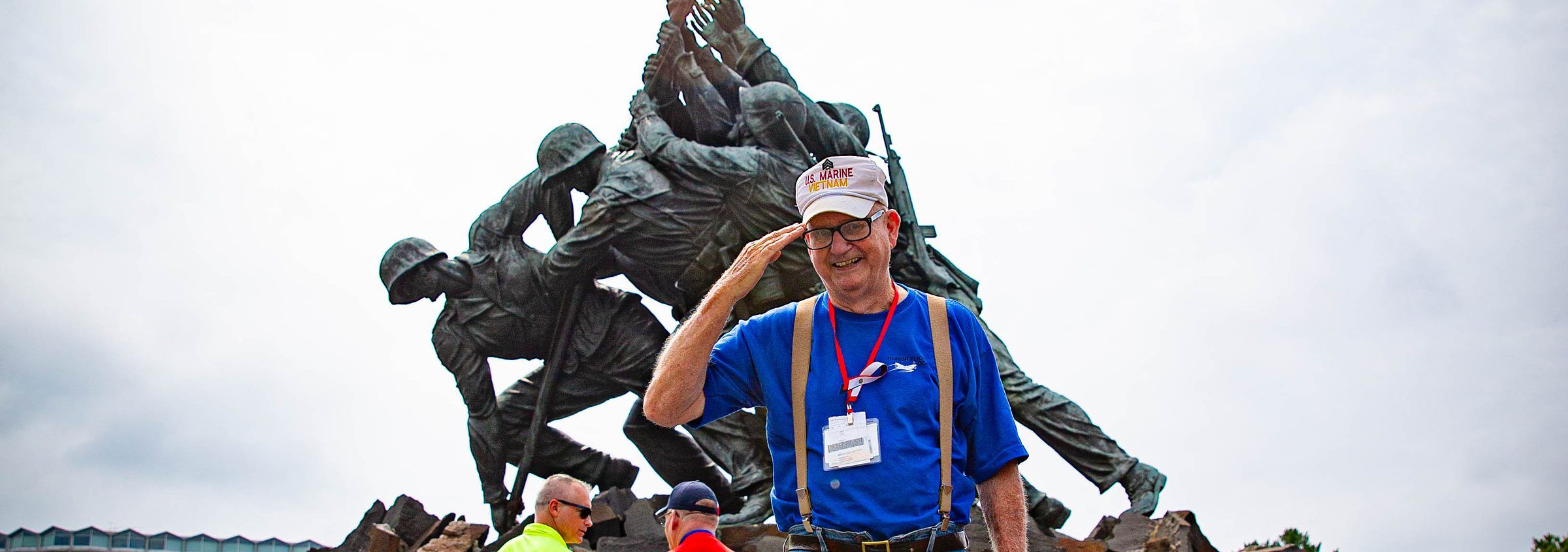 Veteran saluting in front of the Marine Corps War Memorial