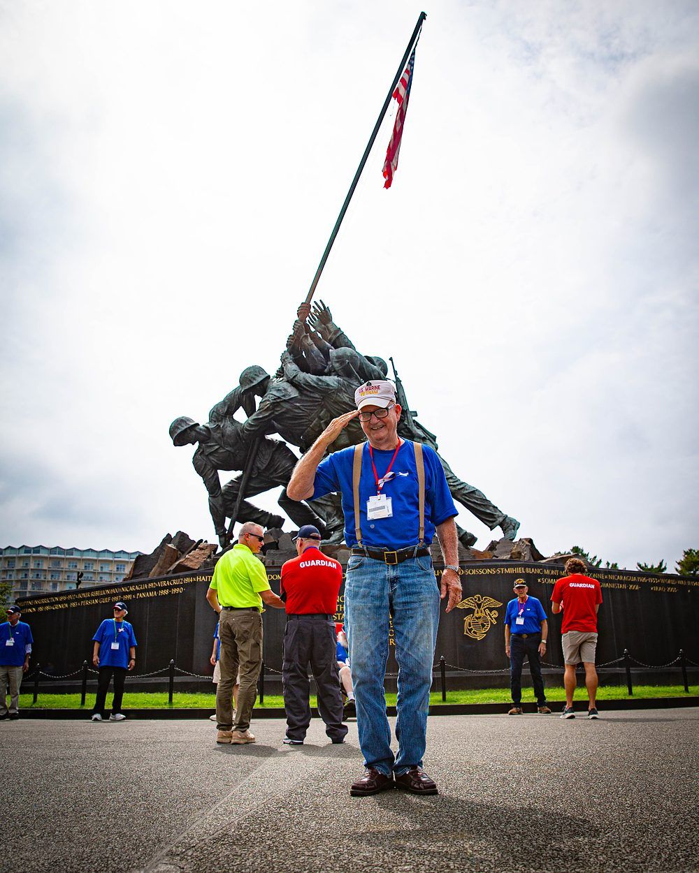 Veteran saluting in front of the Marine Corps War Memorial