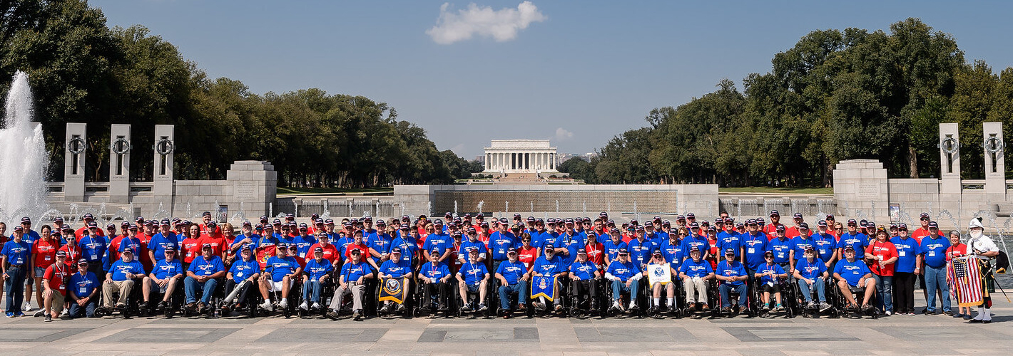 Vietnam Veteran shaking hands of Veteran taking an Honor Flight